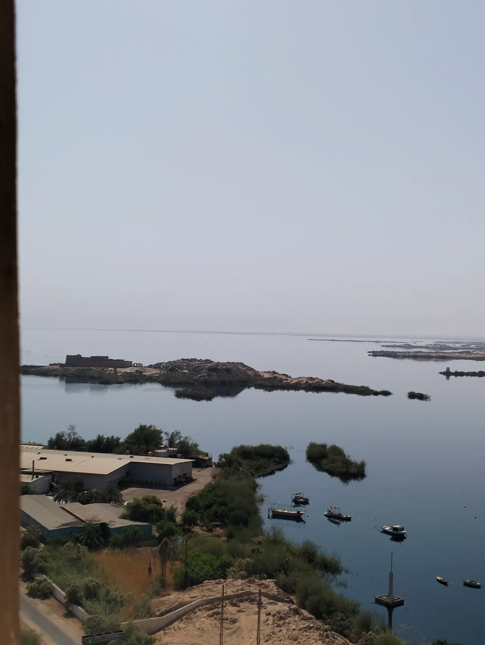 Rocky islands and small boats on the water near Aswan High Dam