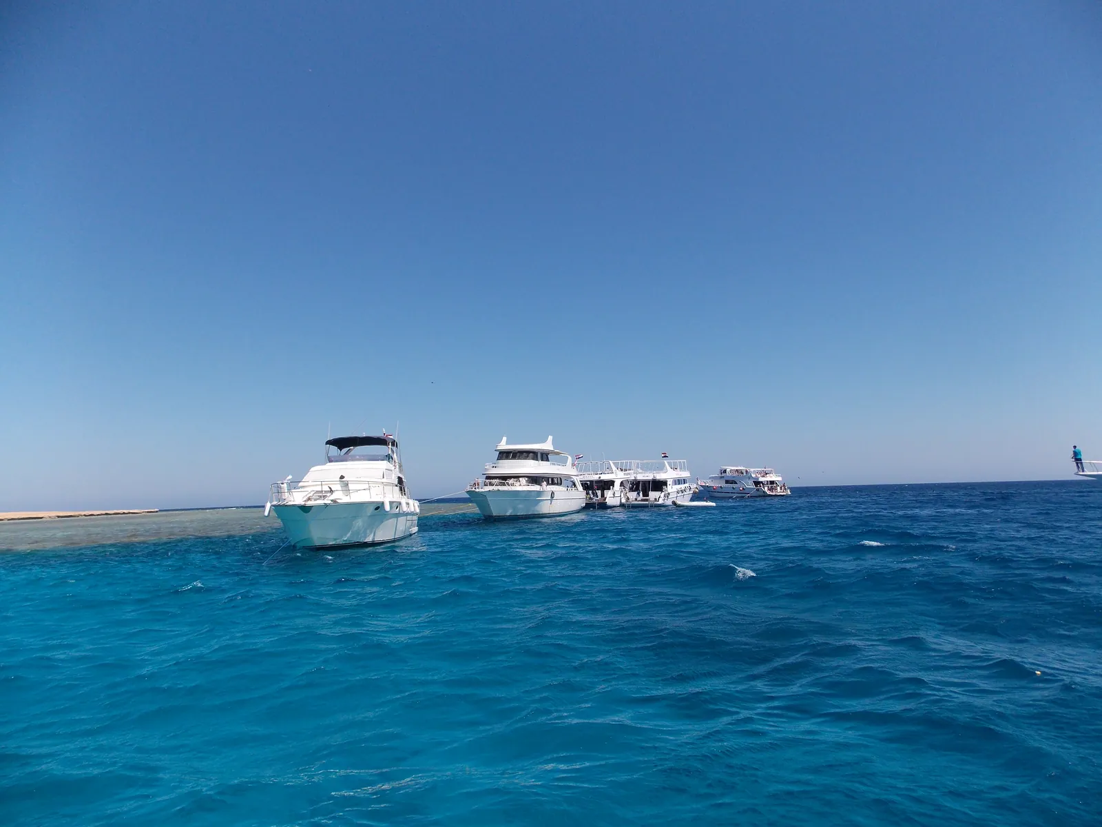 Boats on turquoise water after an Aswan to Hurghada private transfer