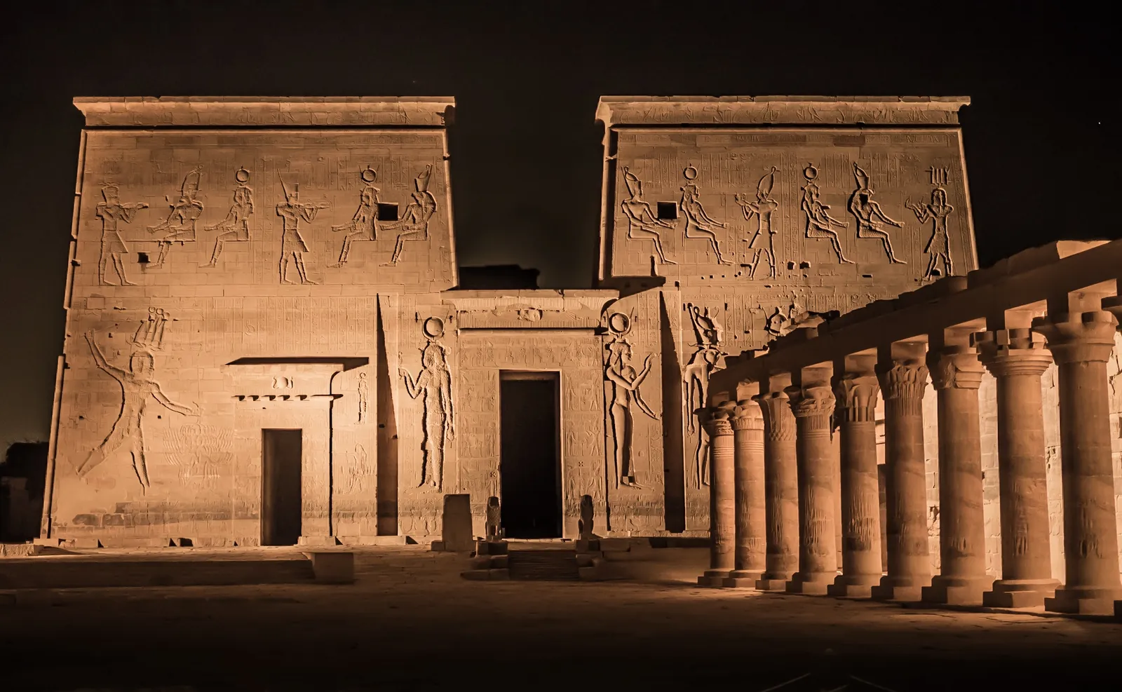 Illuminated first pylon and colonnade of Philae Temple at night